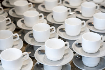 Serving white porcelain coffee and tea cups with saucer
