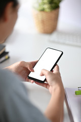 Portrait photo Closeup man using mobile phone on office desk with clipping path empty screen.