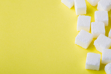 Sugar cube on yellow background