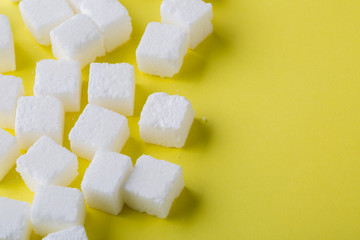 Sugar cube on yellow background