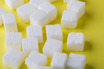 Sugar cube on yellow background