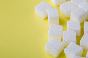 Sugar cube on yellow background