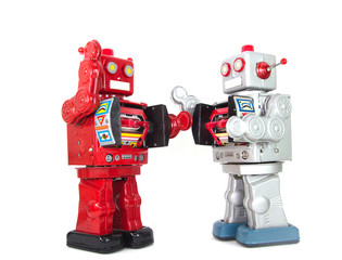 two retro robots having a argument 