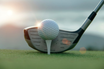 Golf ball and golf club in beautiful golf course at sunset background. Golf ball on green in golf course at Thailand