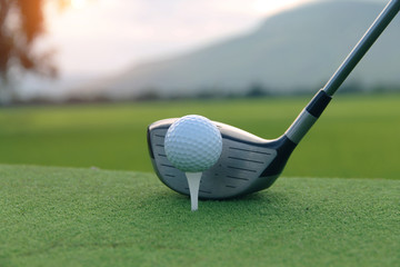 Golf ball and golf club in beautiful golf course at sunset background. Golf ball on green in golf course at Thailand
