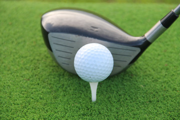 Golf ball and golf club in beautiful golf course at sunset background. Golf ball on green in golf course at Thailand