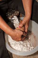 Fototapeta premium woman hands mixing dough on wooden table