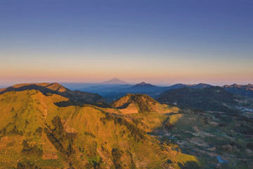 Beautiful Dieng plateau with farmland at dusk
