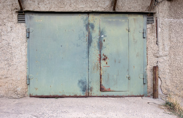 old metal door to the car garage