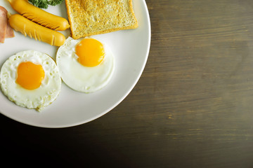 Top view of american breakfast on dark brown wooden table.