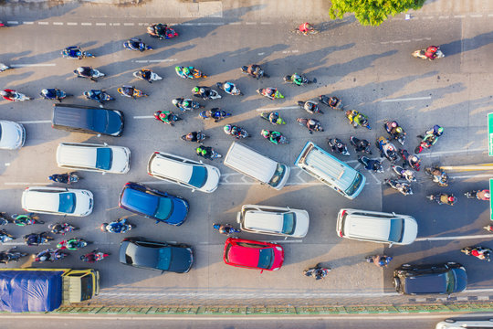 Top down view of cars and motorcycle at rush hour