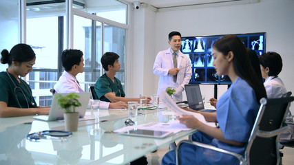 Medical concept. The doctors are seriously meeting in the office.