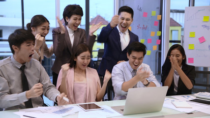 Business concept. A group of businessmen are glad about the success of the company.