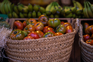Fresh organic produce on sale at the local farmers market. Freshly, seasonal harvested vegetables. Bio, healthy food. Vegetarian food. Ripe organic tomatoes in a basket.