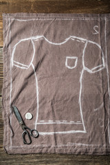 Tailor draft of trousers with scissors in tailoring workshop