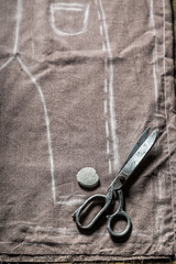 Tailor draft trousers on the material in tailoring workshop