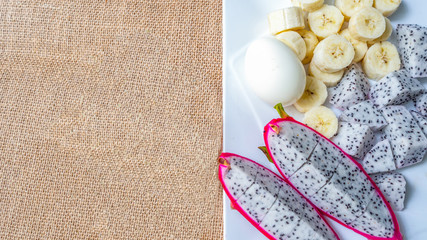 Dragon fruit, banana, boiled eggs and hot tea placed on the table. Concept  Healthy food menu concept.