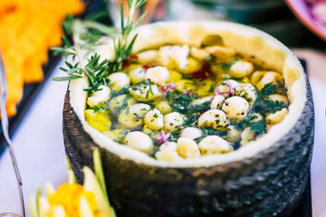 Close up of gourmet tasty delicious traditional cheese with oil and hierbs served on a white table - restaurant and catering concept