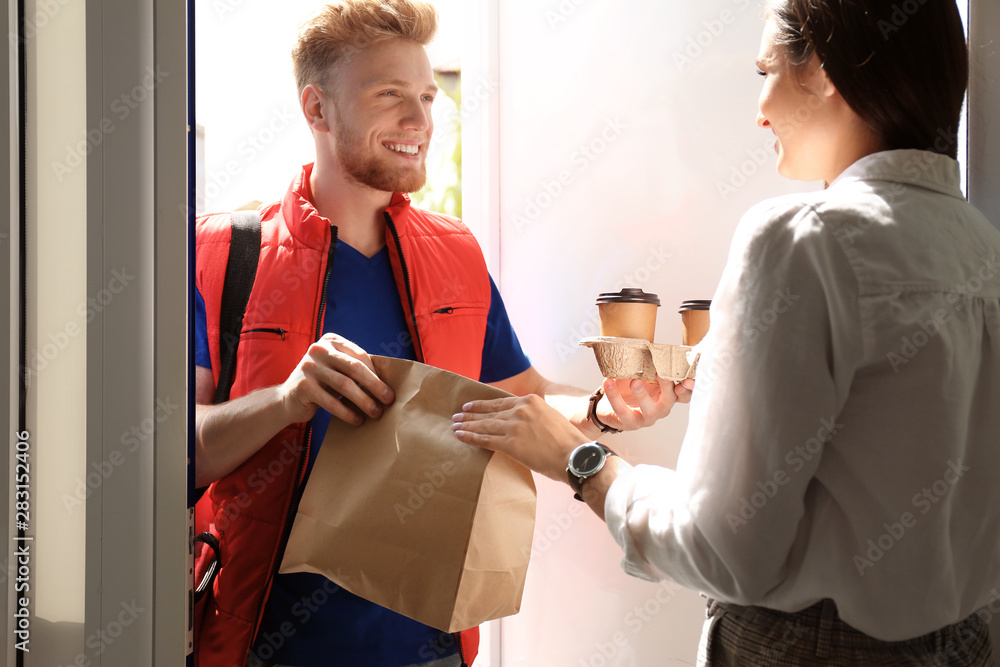 Sticker Courier giving order to young woman at open door. Food delivery service