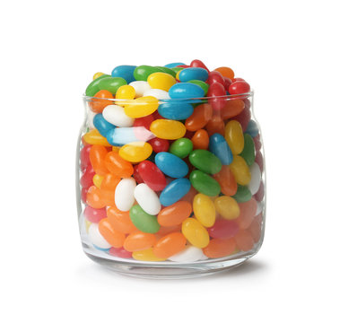 Glass jar of tasty bright jelly beans isolated on white