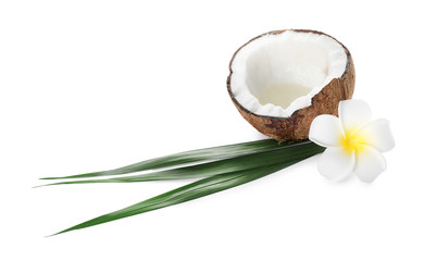 Ripe coconut with natural organic oil, flower and leaves isolated on white