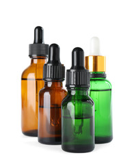 Bottles of herbal essential oils isolated on white