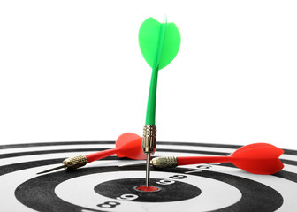 Arrow hitting target on dart board against white background