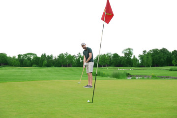 Man playing golf on green course. Sport and leisure