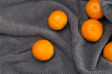 Orange mandarins soft focus on gray tree shape towel background. Recipe, diet, Christmas concept. Flat lay, top view, copy space, close-up, layout design