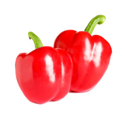 Tasty ripe red bell peppers on white background