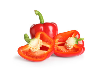 Cut and whole ripe red bell peppers on white background
