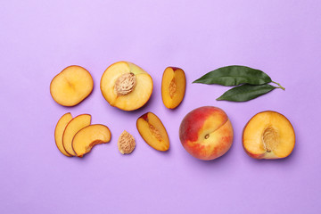 Flat lay composition with sweet juicy peaches on lilac background