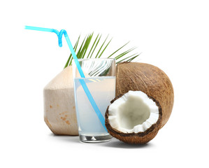 Glass of coconut milk and nuts on white background
