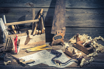 Vintage wooden carpenter drawing desk on rustic wooden table