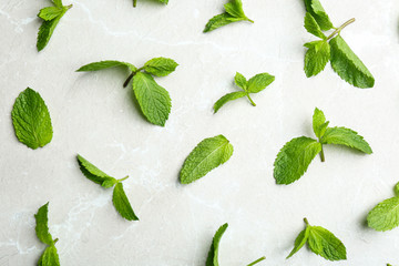 Fresh mint leaves on grey marble background, flat lay