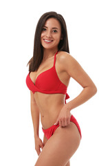Obraz premium Pretty sexy woman with slim body in stylish red bikini on white background