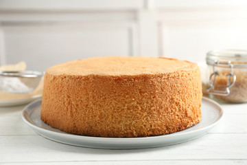 Delicious fresh homemade cake on white wooden table
