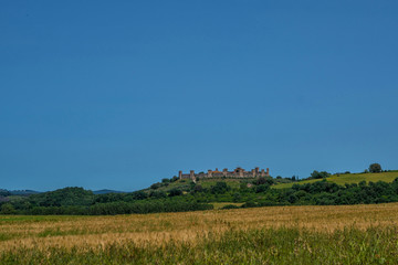 Beautiful view of the small medieval village with stone walls of Monteriggioni in province of Siena, Tuscany Italy.