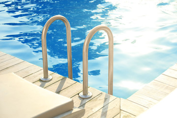 Obraz na płótnie Canvas Modern swimming pool with step ladder outdoor