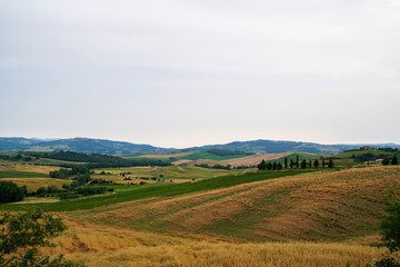 Majestic view of typical Tuscany countryside nature landscape. Beautiful hills at the sunrise time, fields and rural road. Italy, Europe. Holiday, traveling concept.