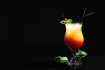 Just made appetizing cocktail Sex on the Beach, black background. Space for text