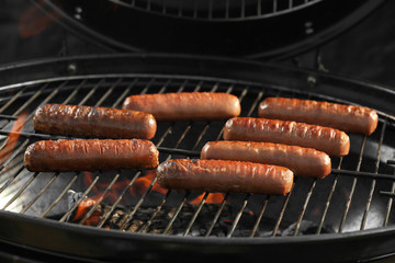 New modern barbecue grill with tasty sausages, closeup