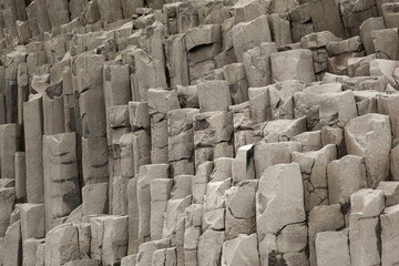 Basalt columns ( formation ) in Iceland on mountain Reynisfjall. Texture stone close-up
