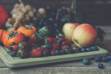 Vintage wooden tray and fresh fruits on wooden table. Fresh organic fruits.