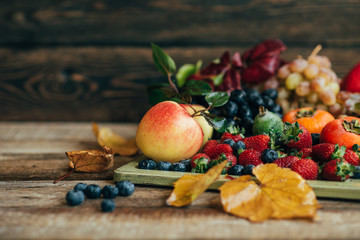 Fresh and colorful fruits in a wooden tray. Healthy fruits.