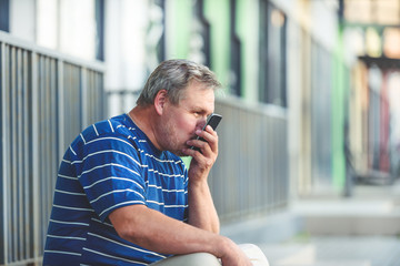 Man happily kisses the smartphone screen - remote communication with a loved one through telecommunications