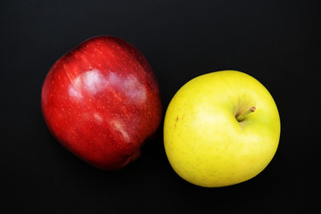 Red and yellow apples on a dark background close-up