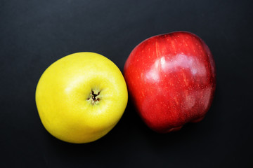 Red and yellow apples on a dark background close-up