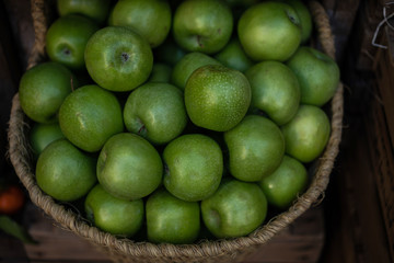 Stall at farmers fresh food market. Ripe organic apples in a basket. Freshly, seasonal harvested fruits. Agriculture products.