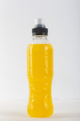 Isotonic energy drink. Bottles with yellow transparent liquid, sport beverage on a white background